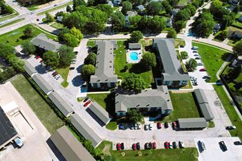 arial view of a house with a pool and parking lot